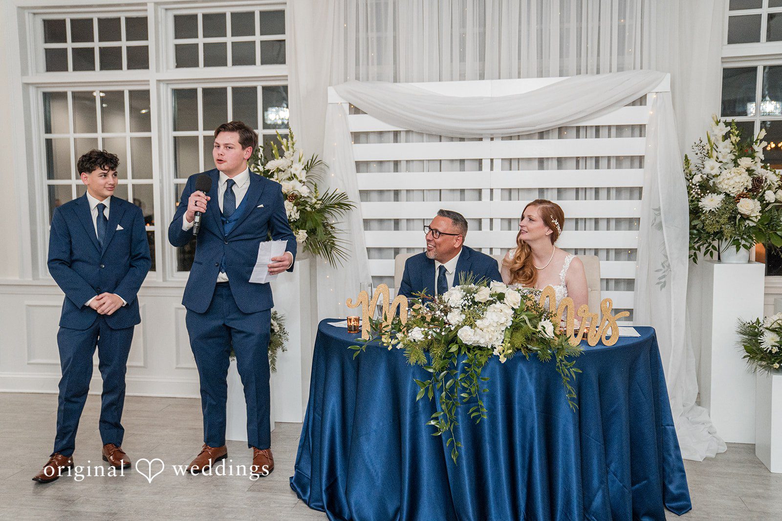Caitlyn + Greg Couple talking with a guest during the wedding ceremony.