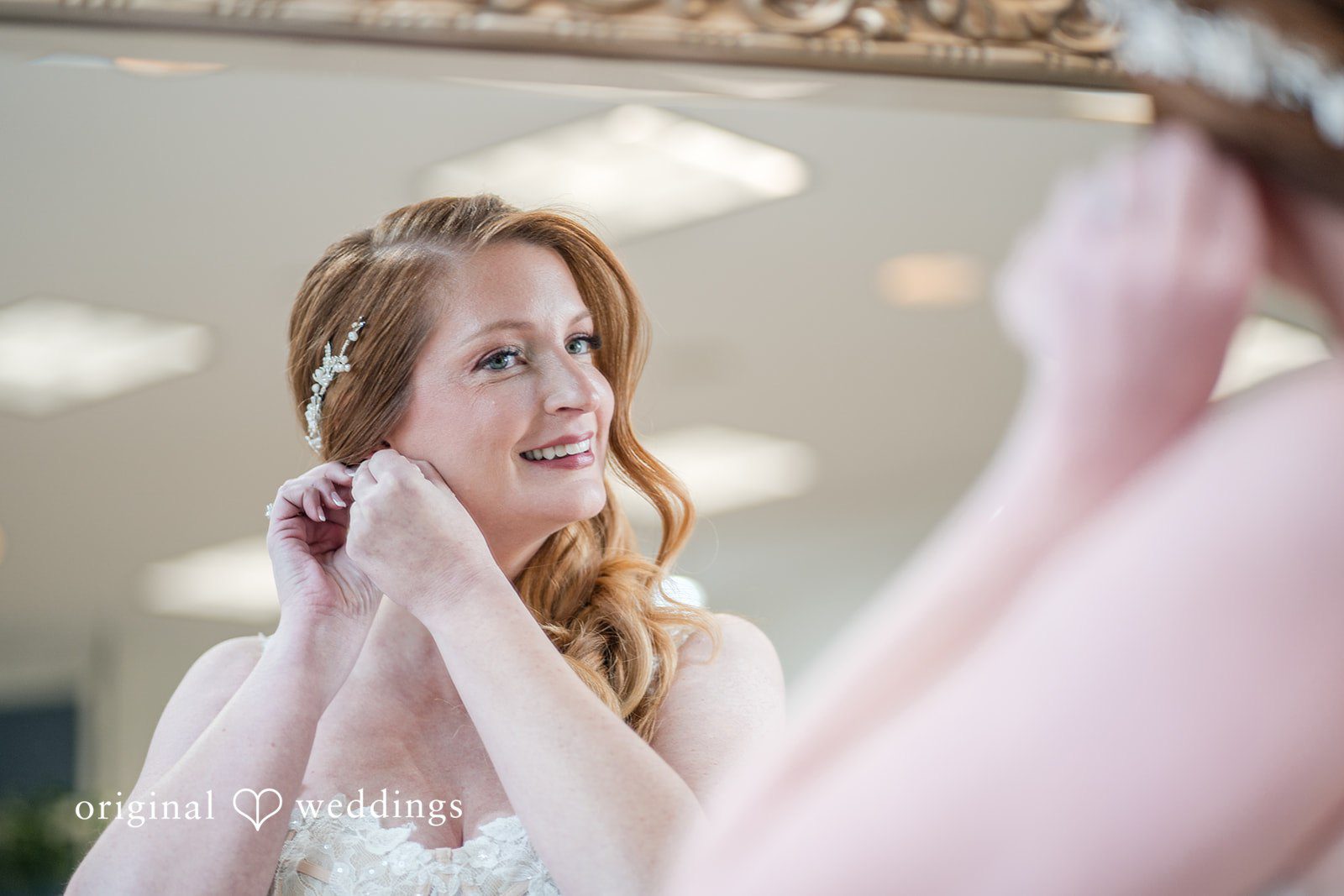 Caitlyn + Greg Bride adjusting earrings while getting ready.