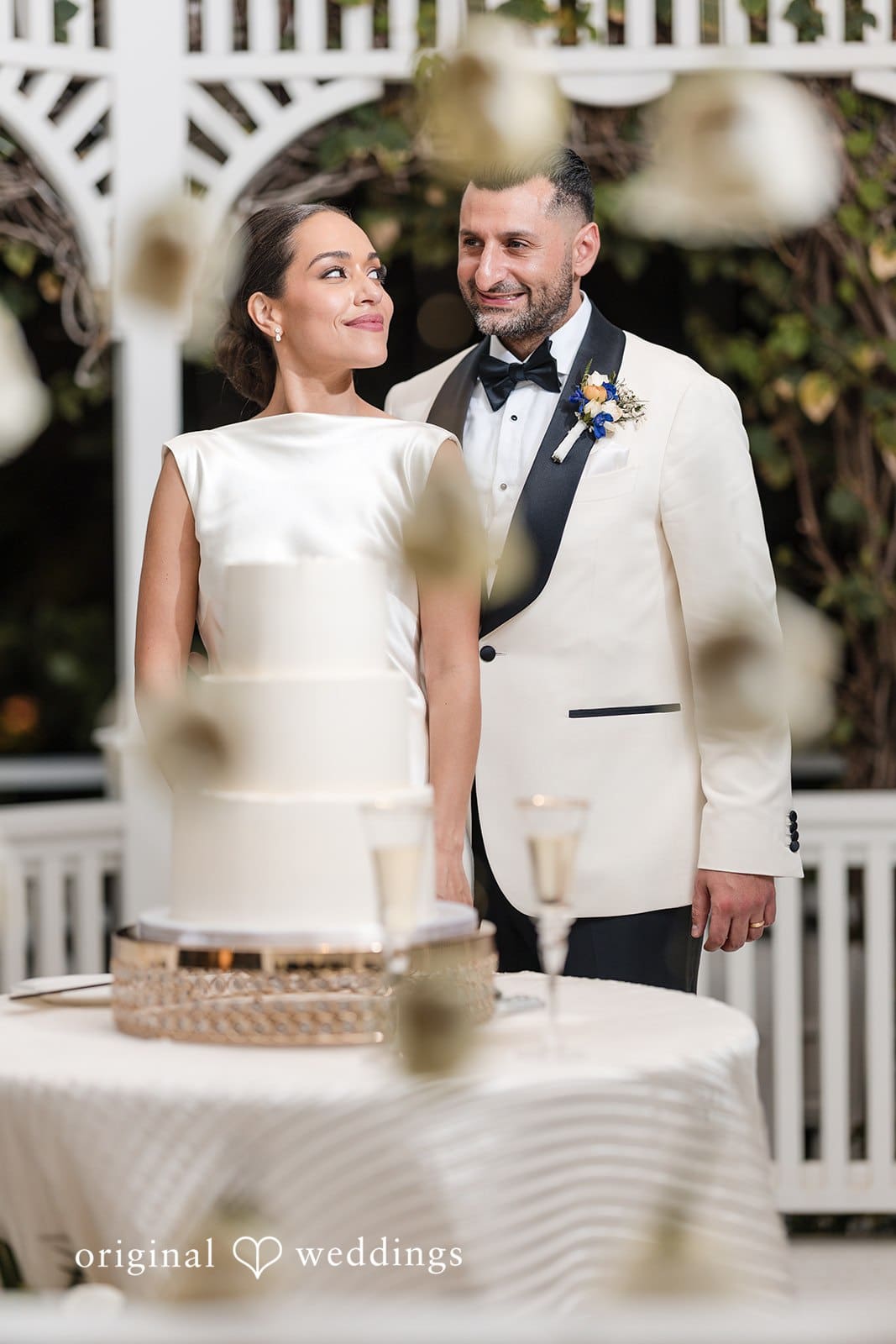 Wedding day photo of bride and groom near cake at The Palms Hotel & Spa