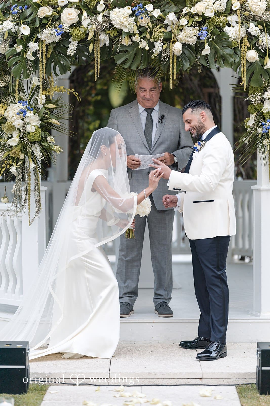 Bride and groom exchanging rings at The Palms Hotel & Spa