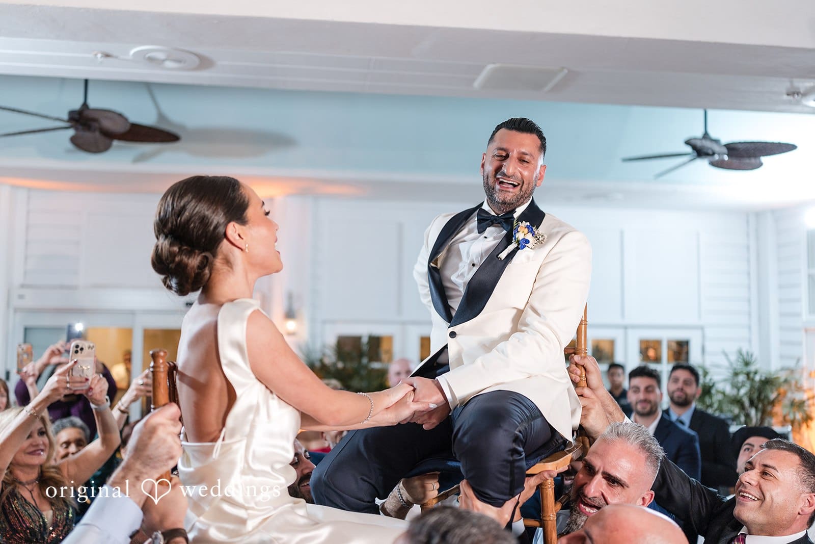 Bride and groom holding each other's hands