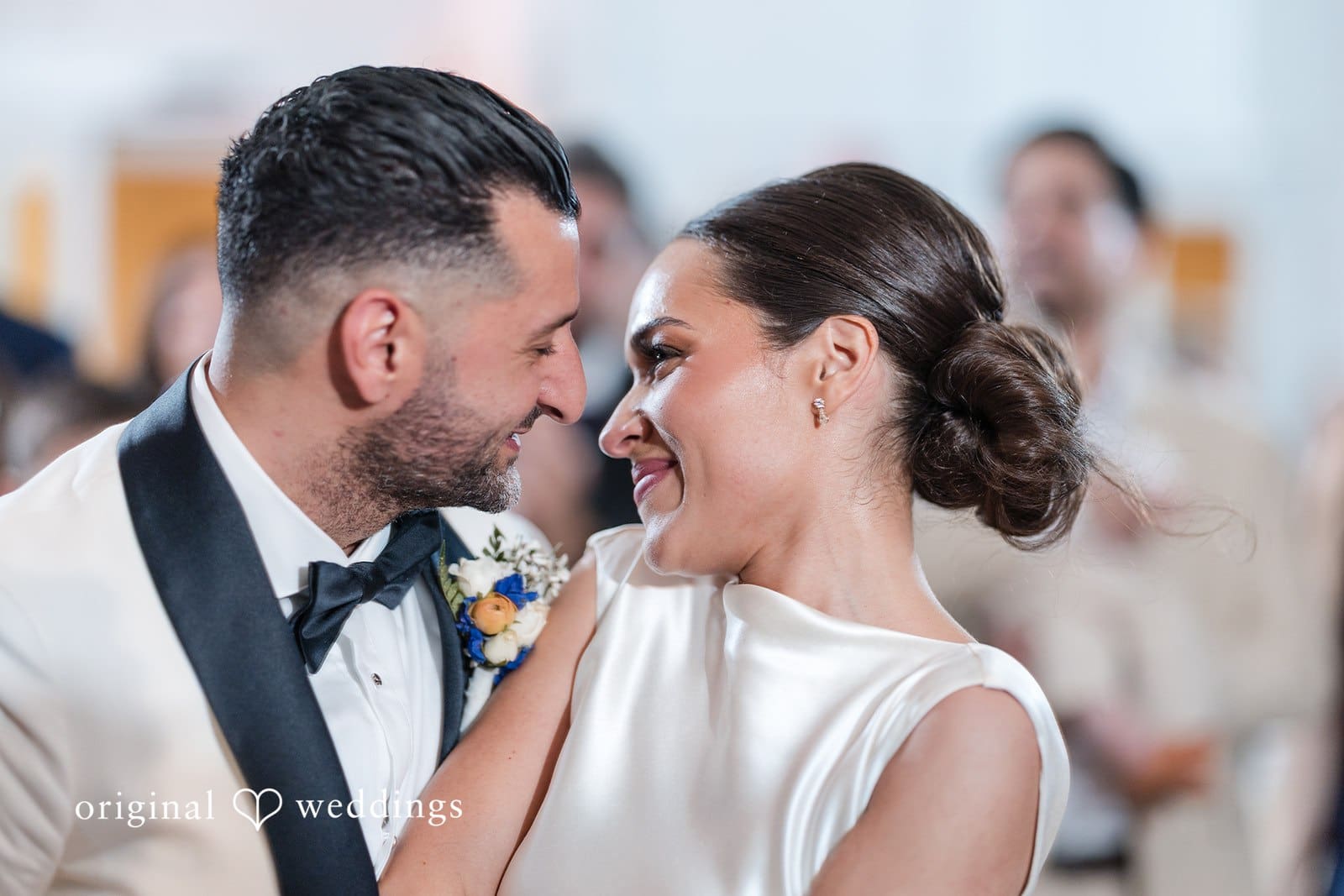 Wedding moment with groom gazing at bride while photo is captured
