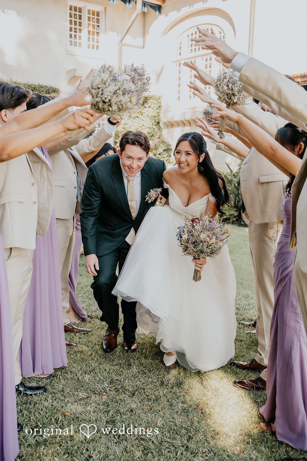 Trisha + Jacob The couple celebrates under a joyful arch of friends.
