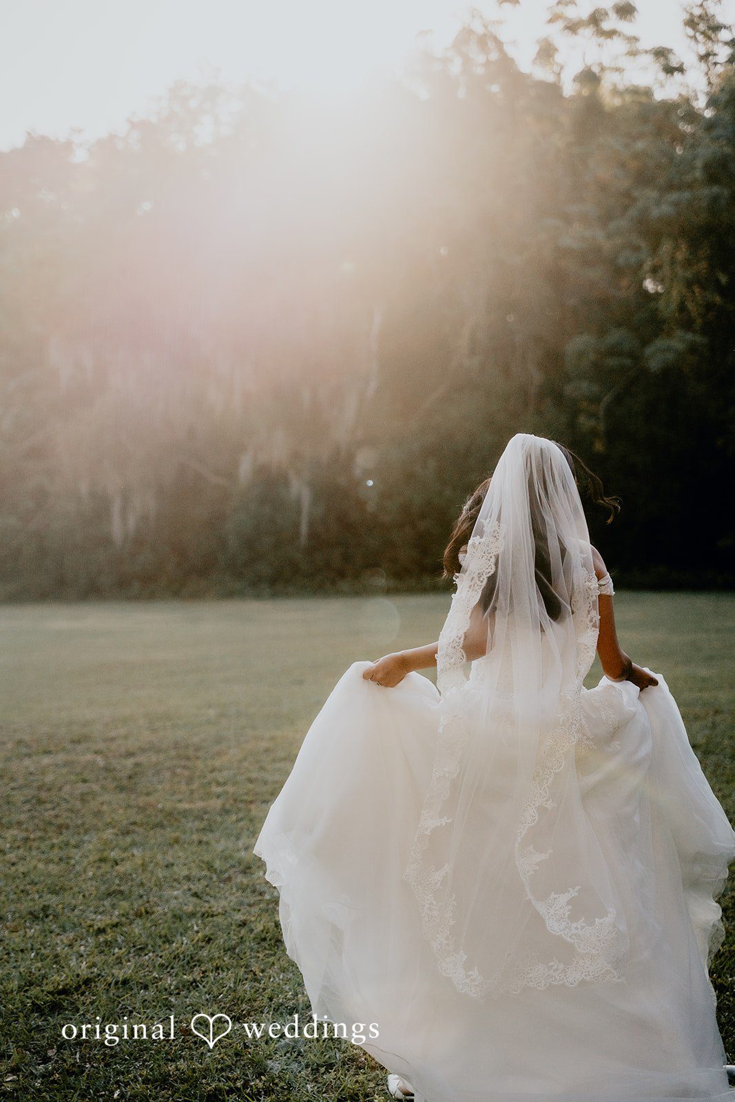 The bride walks gracefully in a dreamy outdoor setting.