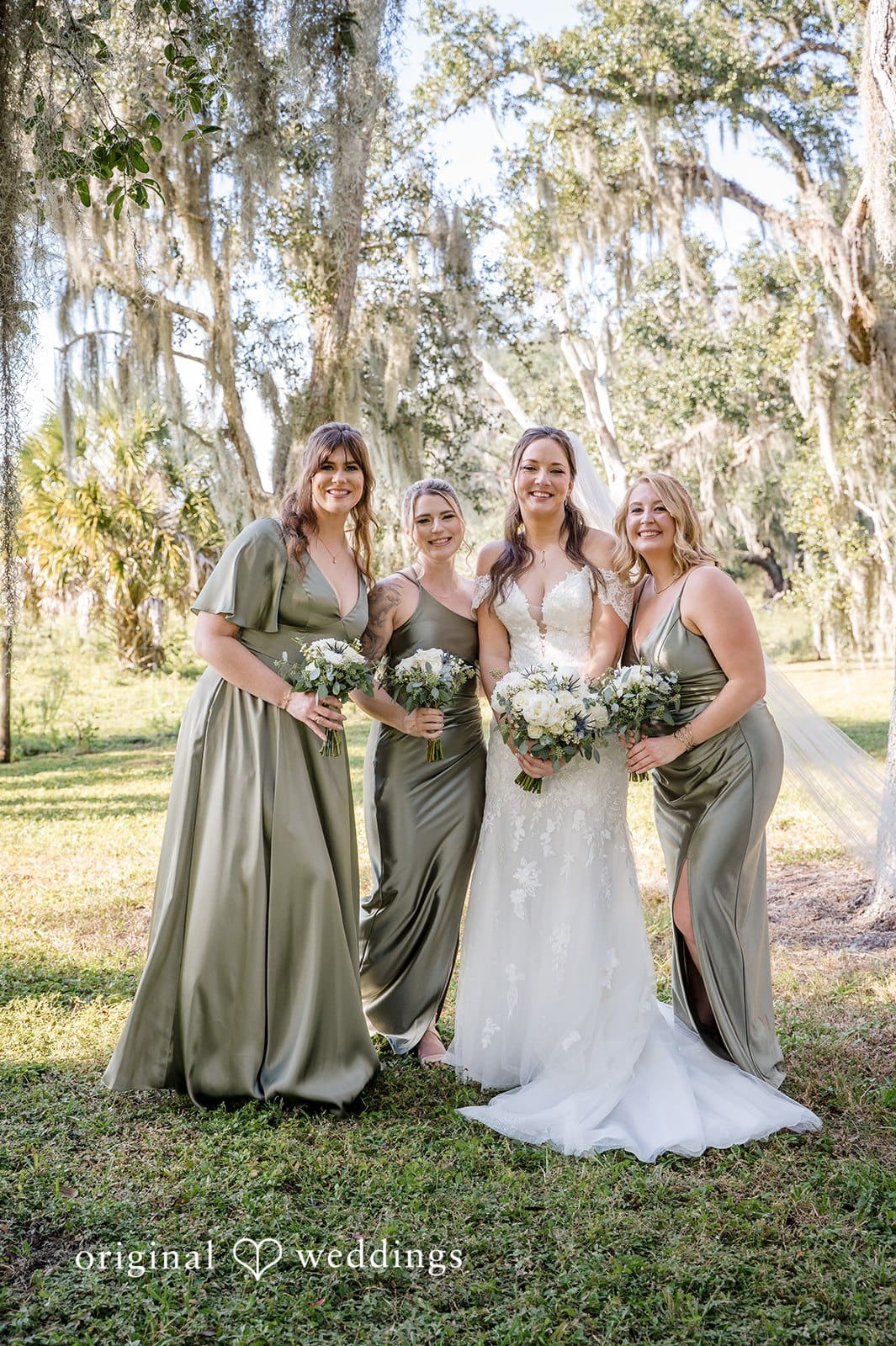 The bride shares a joyful and harmonious moment with her bridesmaids.