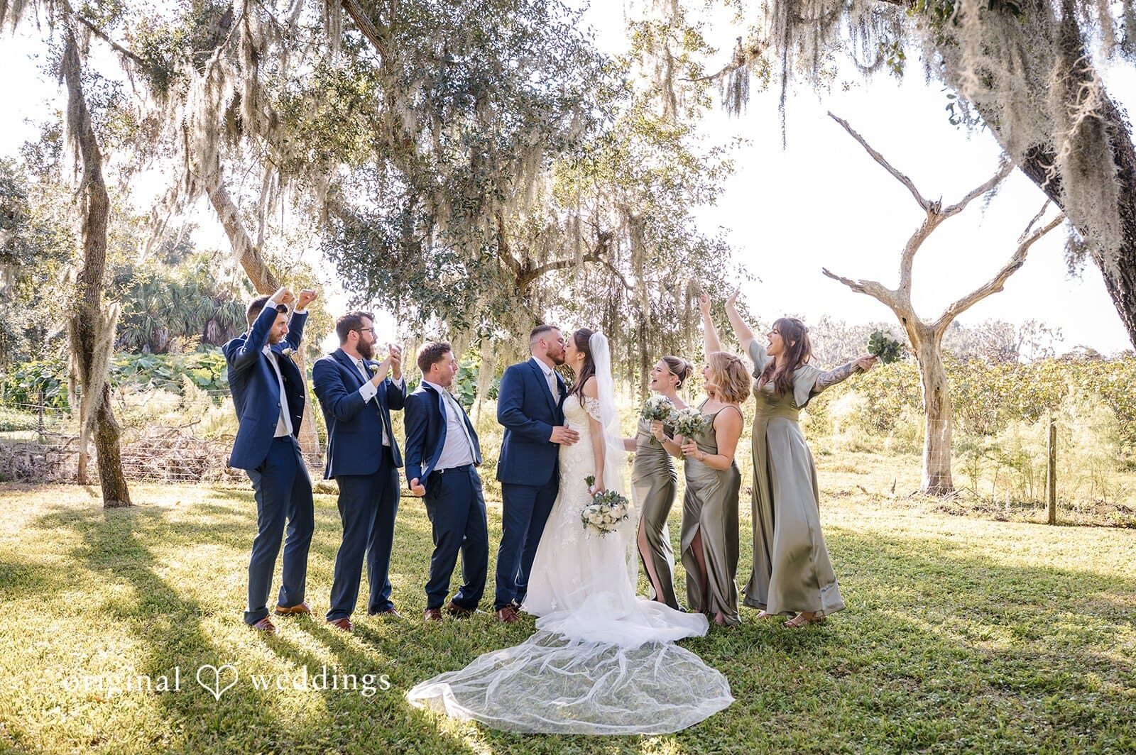 The groom and his friends pose stylishly outdoors with Tampa wedding photography