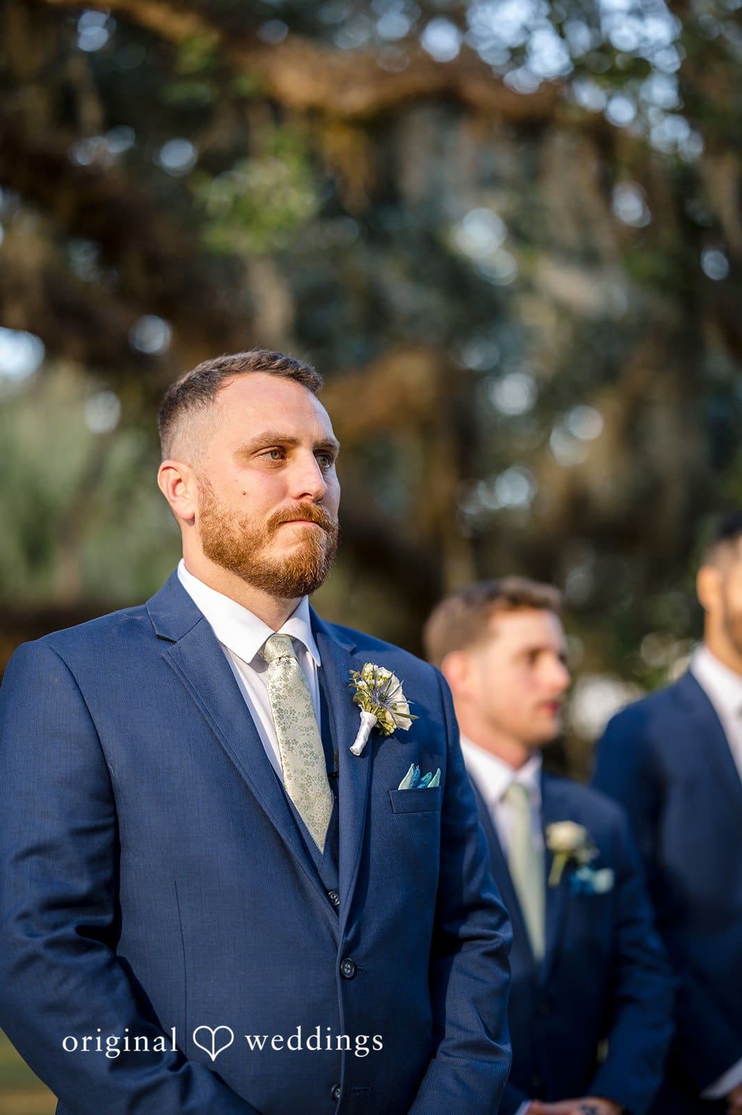 The groom stands confidently and elegantly during the ceremony.