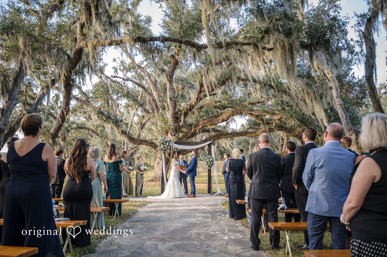 The bride and groom focus on each other with loving gazes during the ceremony.