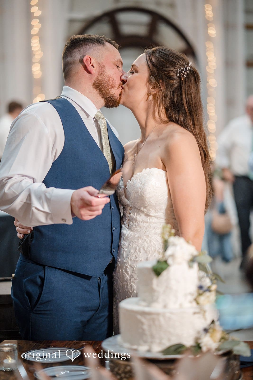 The couple shares a loving moment during the cake cutting.