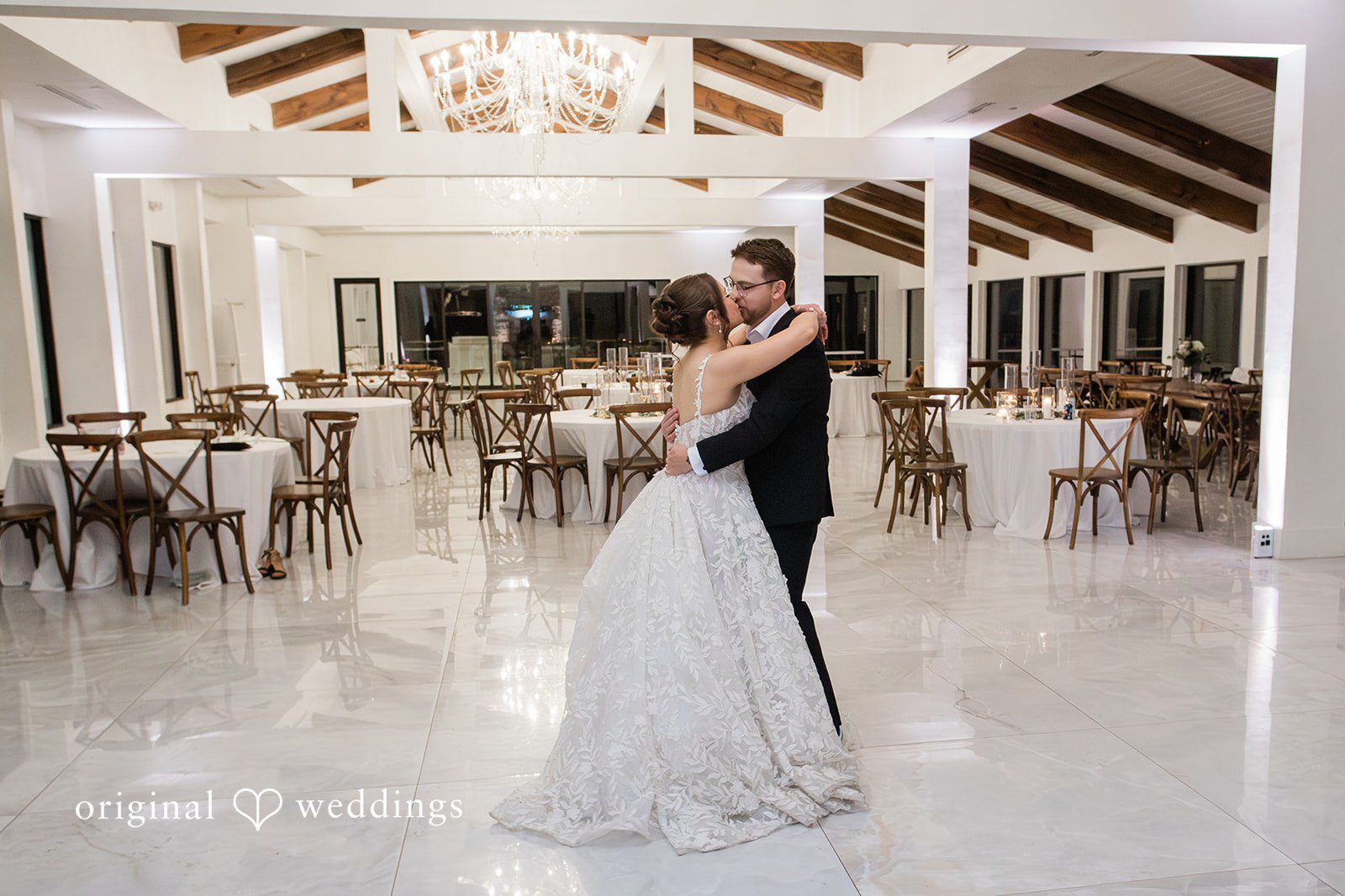 The couple shares a kiss at their wedding reception hall