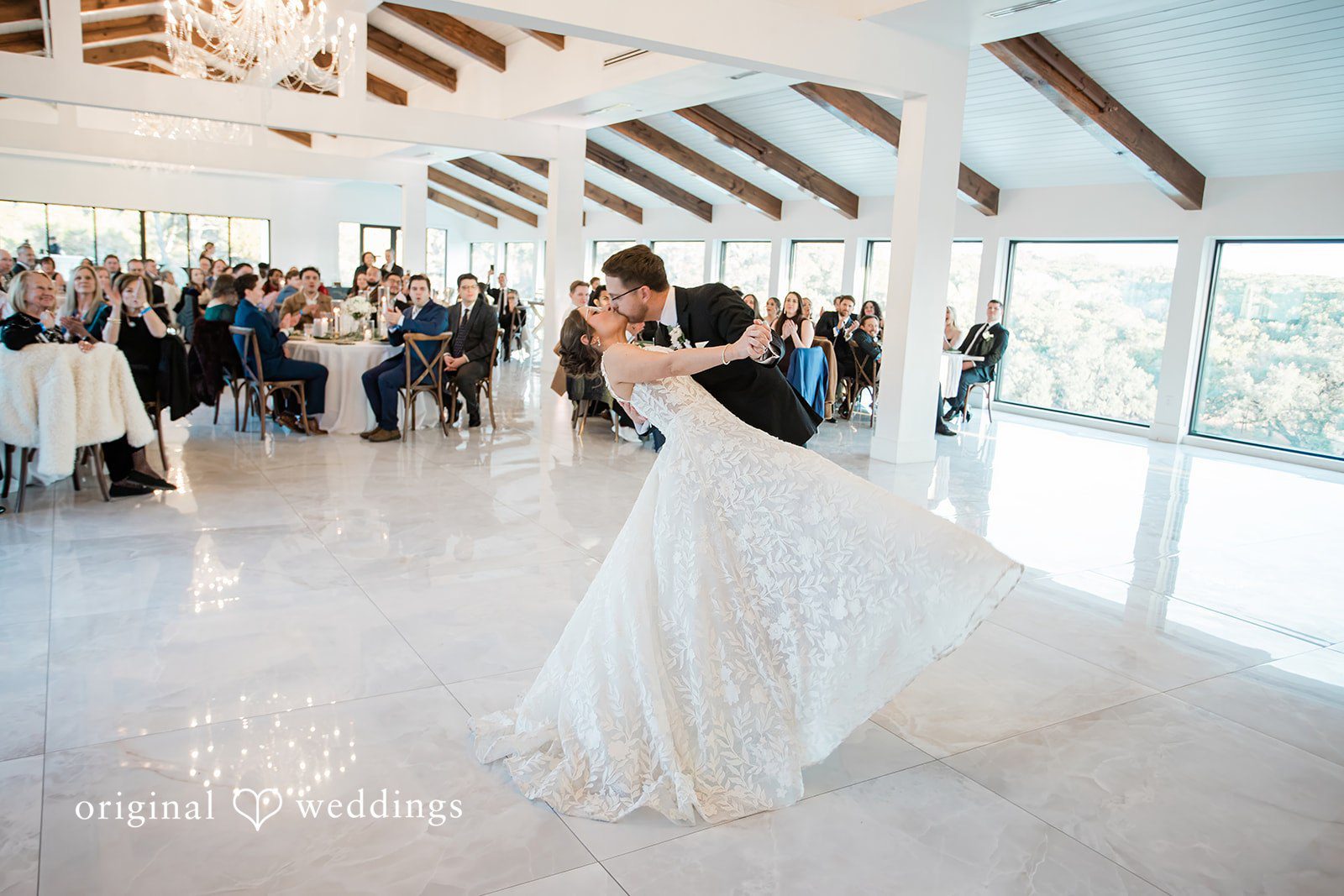 The couple shares a romantic kiss at their wedding reception