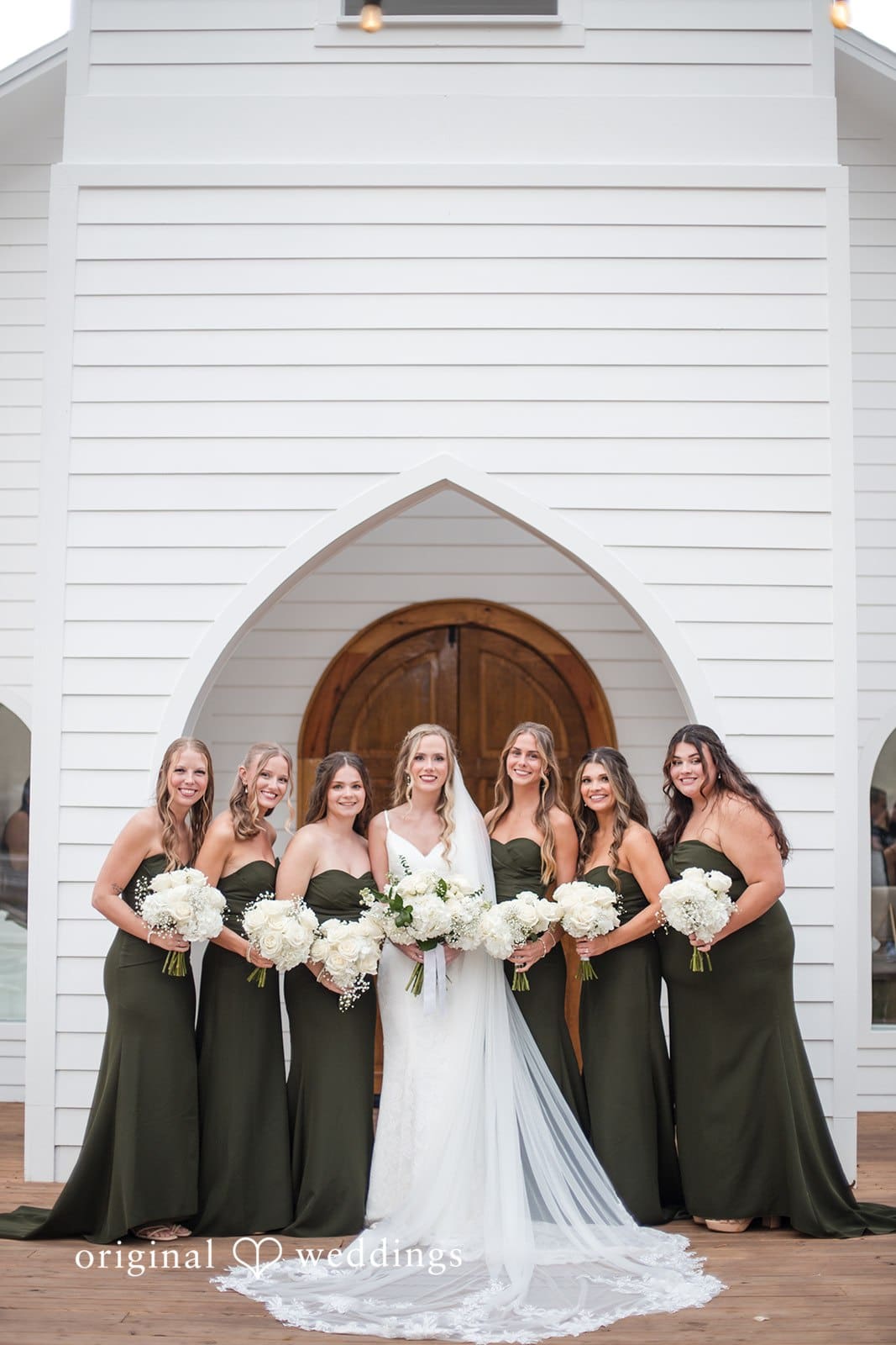 Brianne + Luke Bride with bridesmaids sharing joyful moment at The Whitewood Ranch