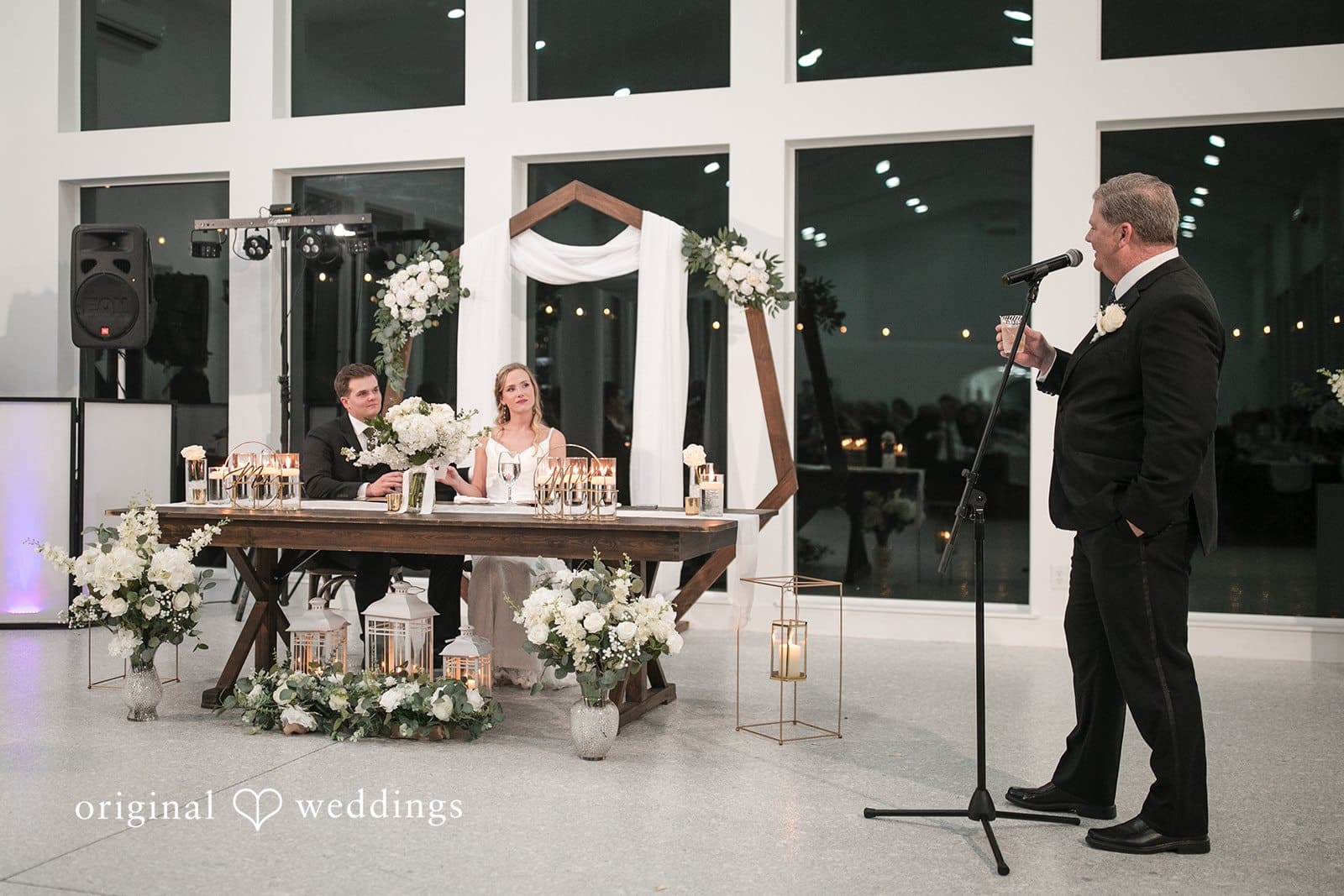 Brianne + Luke Wedding couple sitting and listening to speech during reception