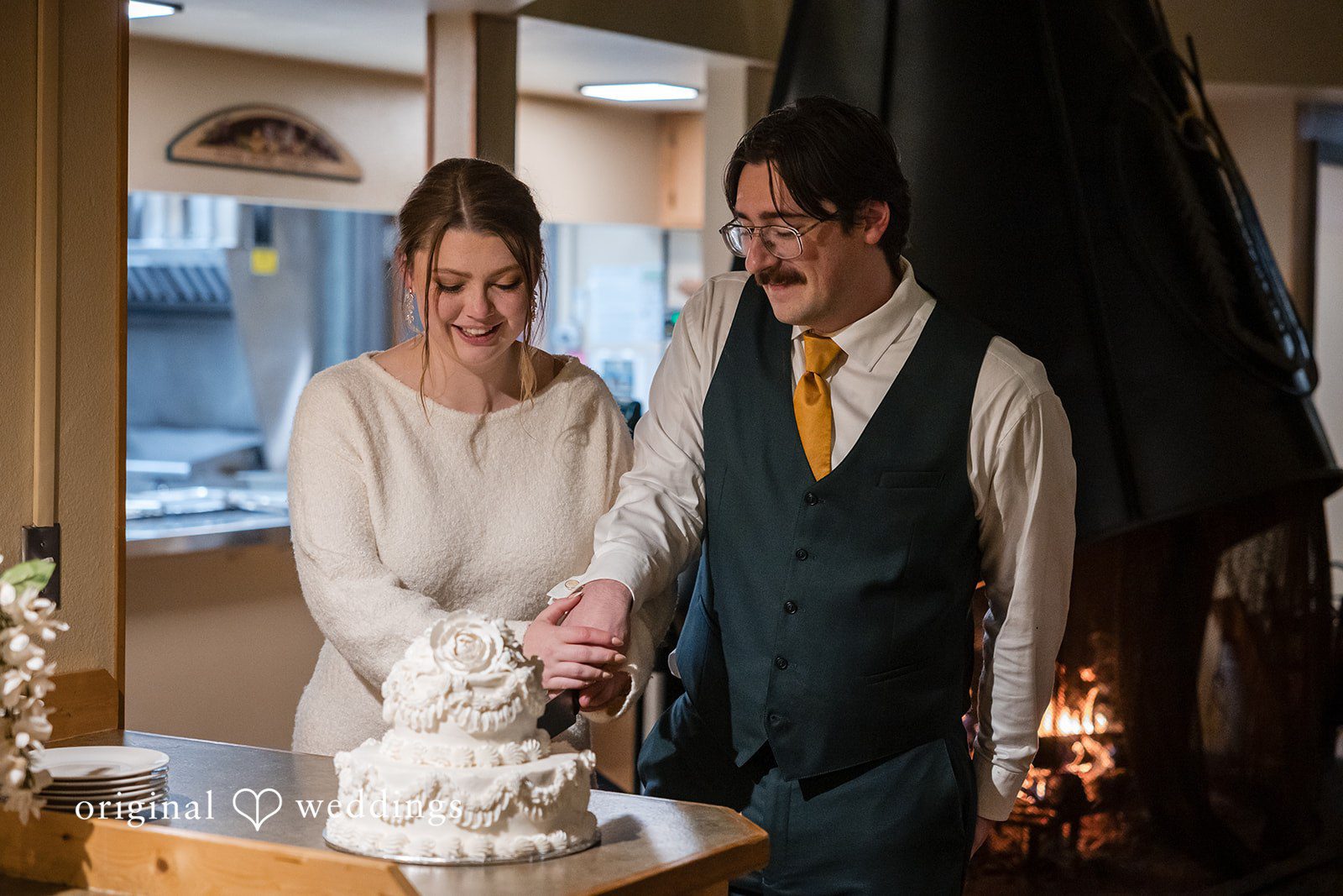 The couple cuts their wedding cake