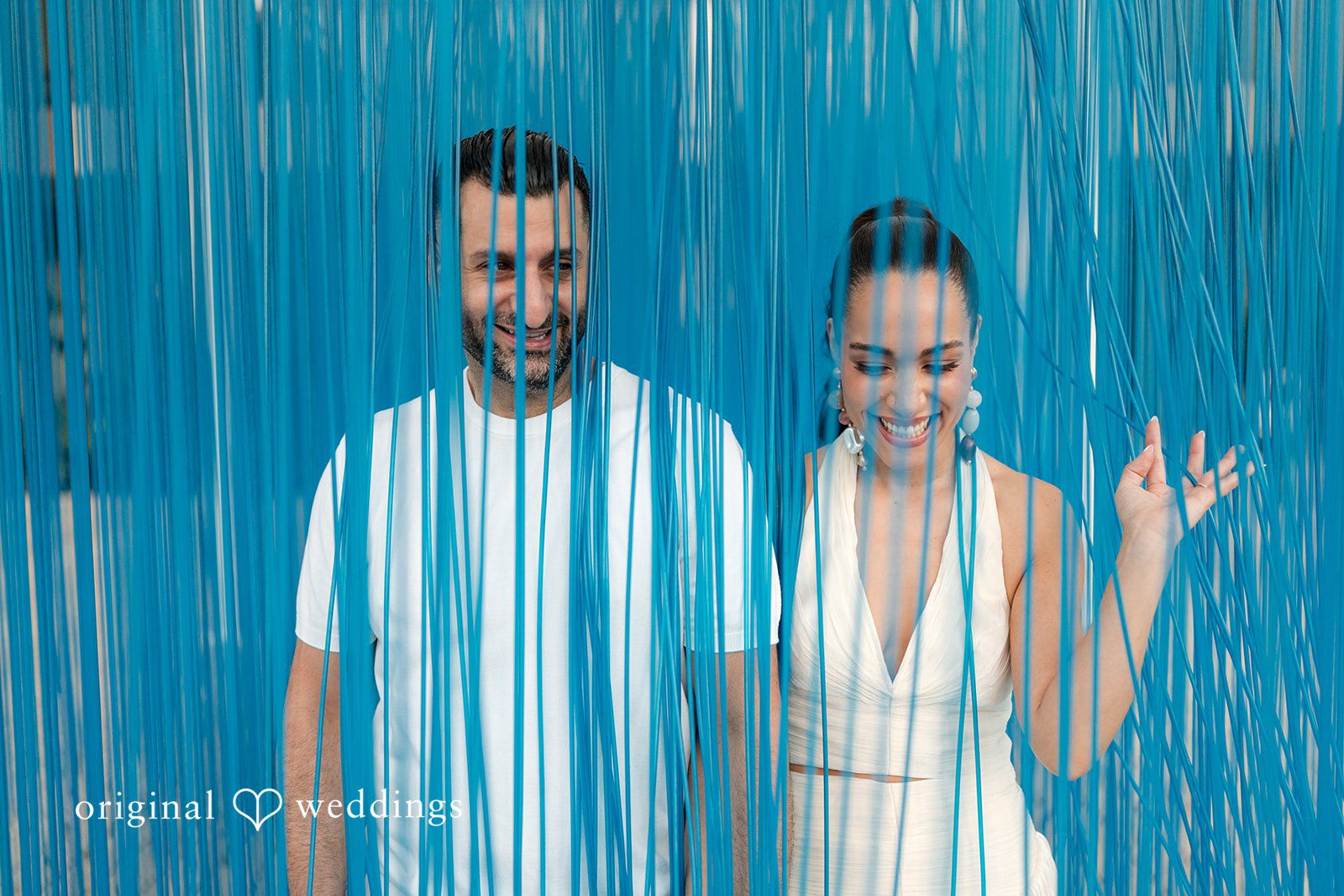 A creative portrait behind textured blue curtains.