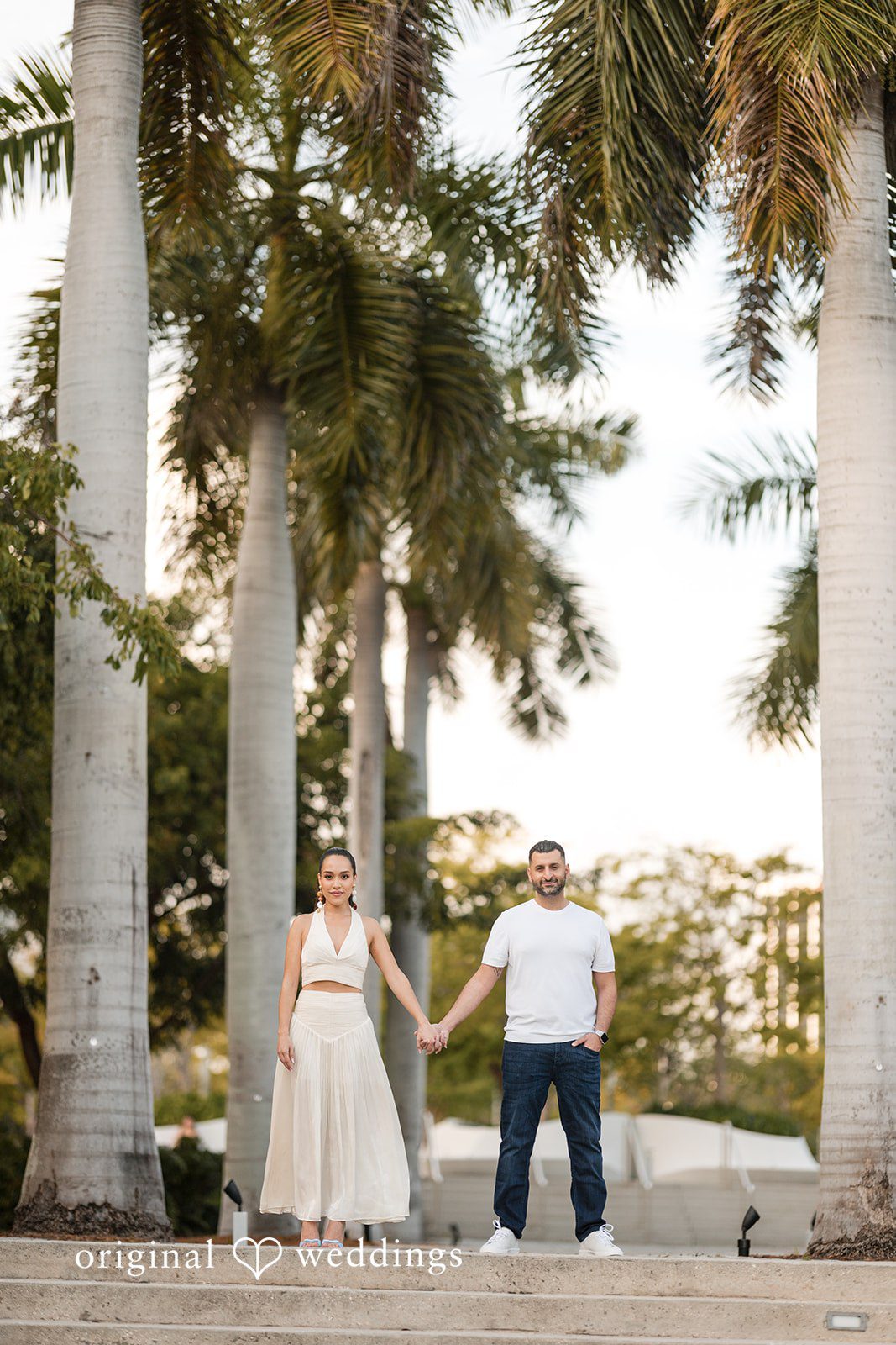 Walking together through a palm-lined path in harmony.