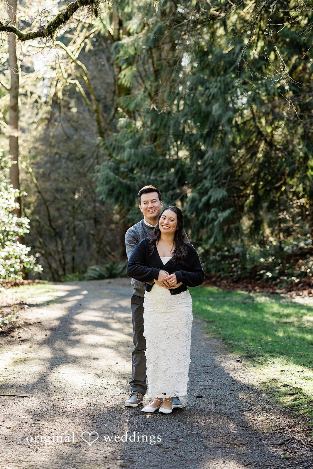 Groom hugging bride from behind at Washington Park Arboretum