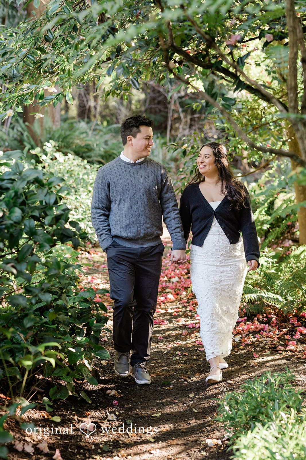 Close-up of couple smiling while walking hand-in-hand at Washington Park Arboretum