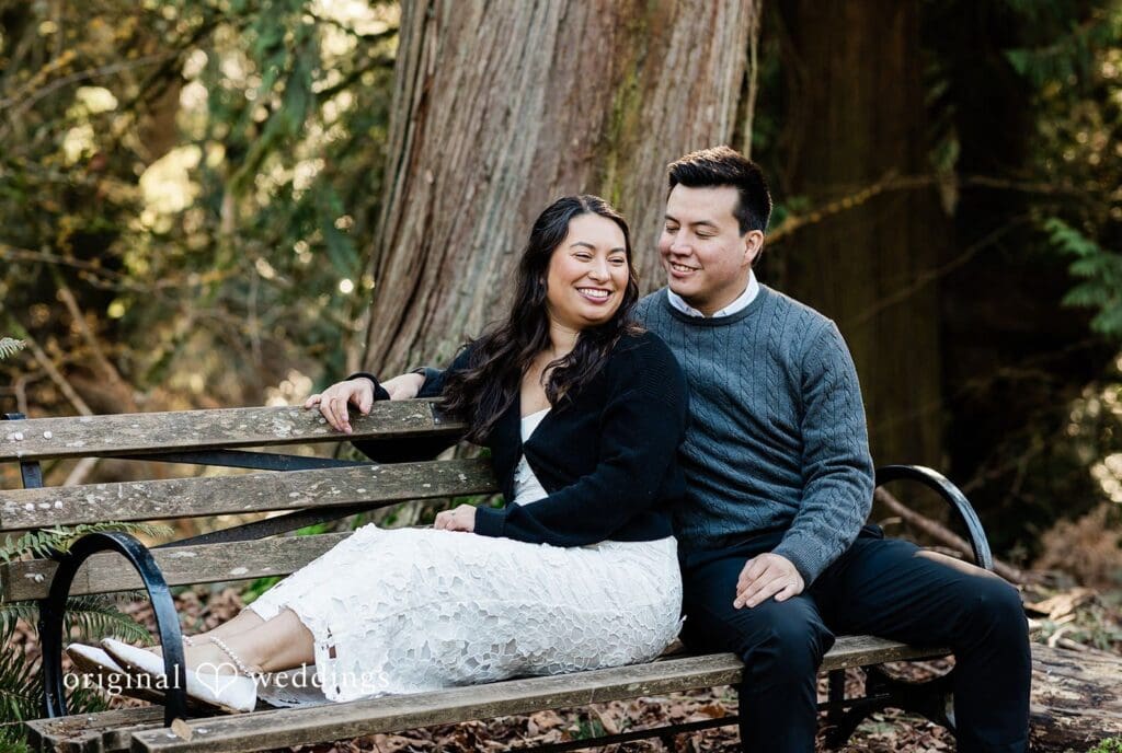 Engagement photography services by Original Weddings capturing close-up of couple smiling while sitting together on a bench at Washington Park Arboretum