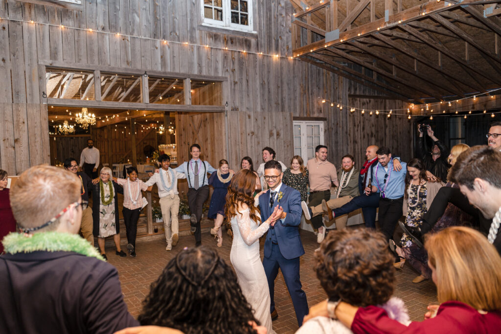 Gregorio + Macy bride and groom dancing with guests at wedding reception venues st louis