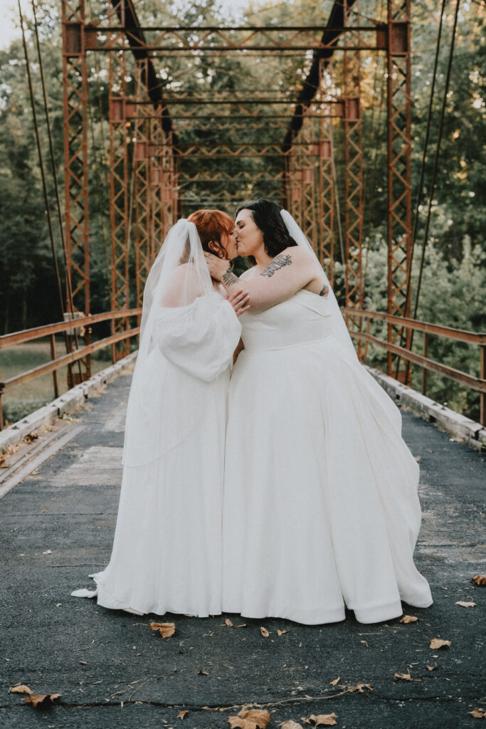 Jaelynn + Elese two brides sharing a kiss at wedding ceremony venues st louis