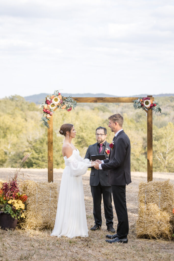 Jacob + Maria outdoor ceremony under wedding arch at wedding venues st louis
