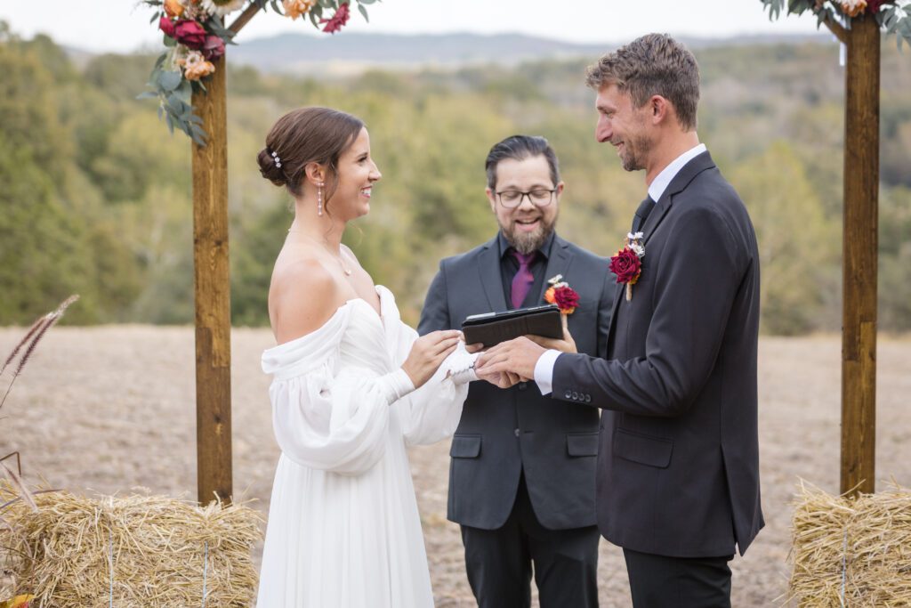 Jacob + Maria couple exchanging vows under wedding arch at wedding venues st louis