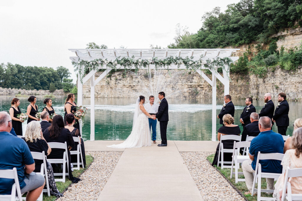 Gabriella + Alex couple saying vows at water side wedding ceremony venues st louis