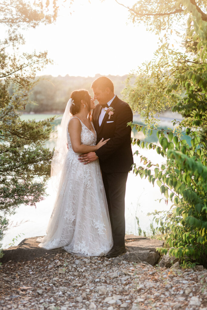 Gabriella + Alex bride and groom sunset by greenery and water at best wedding venues st louis