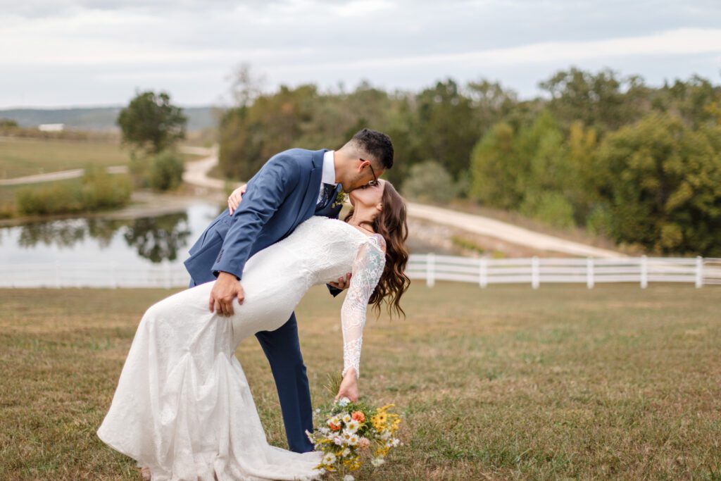 Gregorio + Macy romantic kiss in open landscape captured by st louis wedding photographer