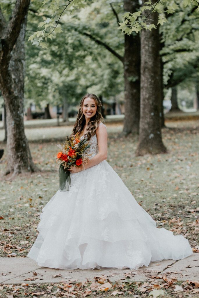 Drew + Bailee bride portrait in greenery with bouquet at wedding venues st louis