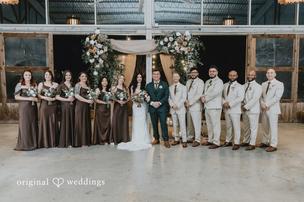 Our Austin wedding photographers at Original Weddings captured a stunning portrait of the couple with their bridal party at the Barr Mansion