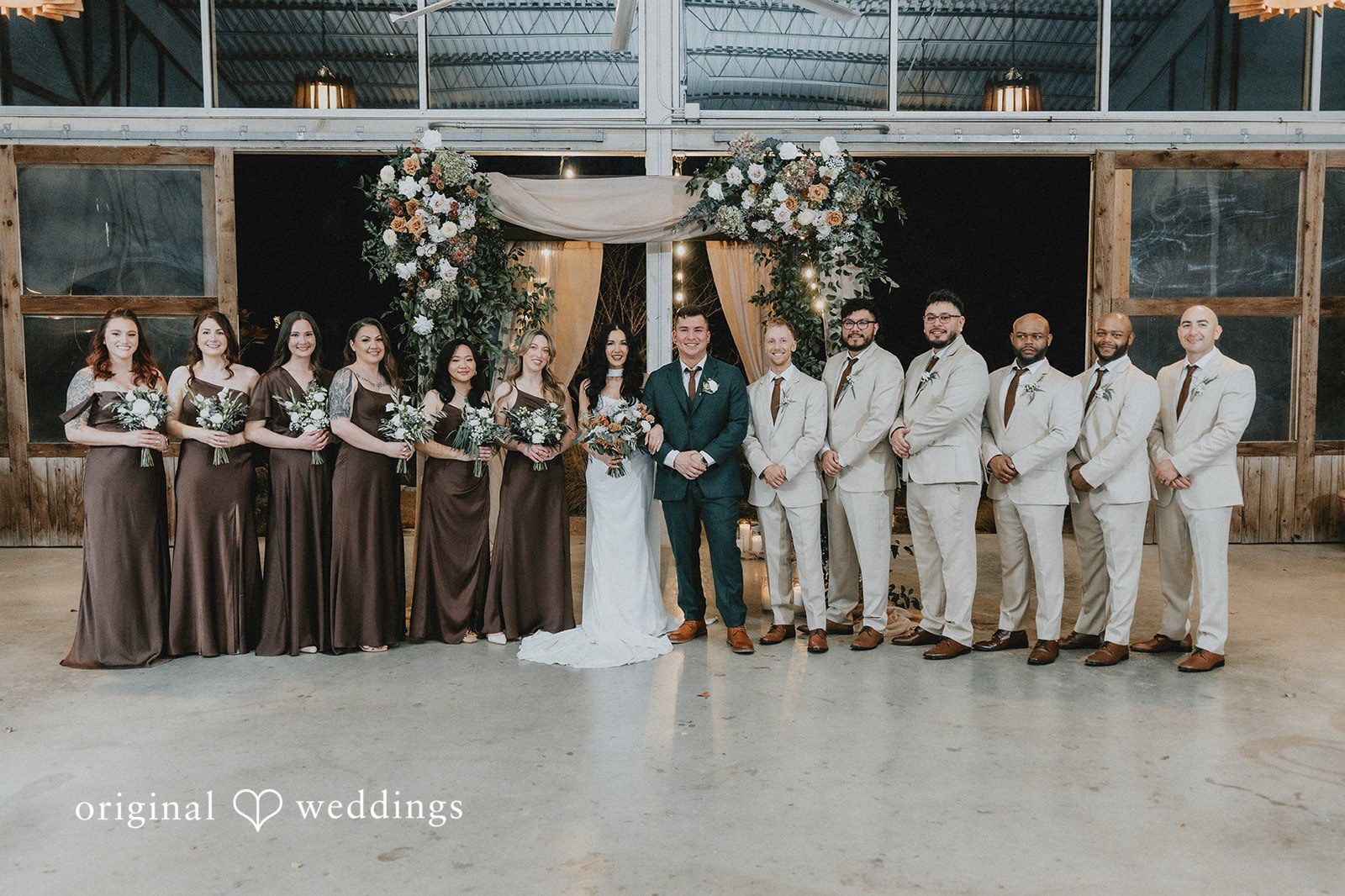 Our Austin wedding photographers at Original Weddings captured a stunning portrait of the couple with their bridal party at the Barr Mansion
