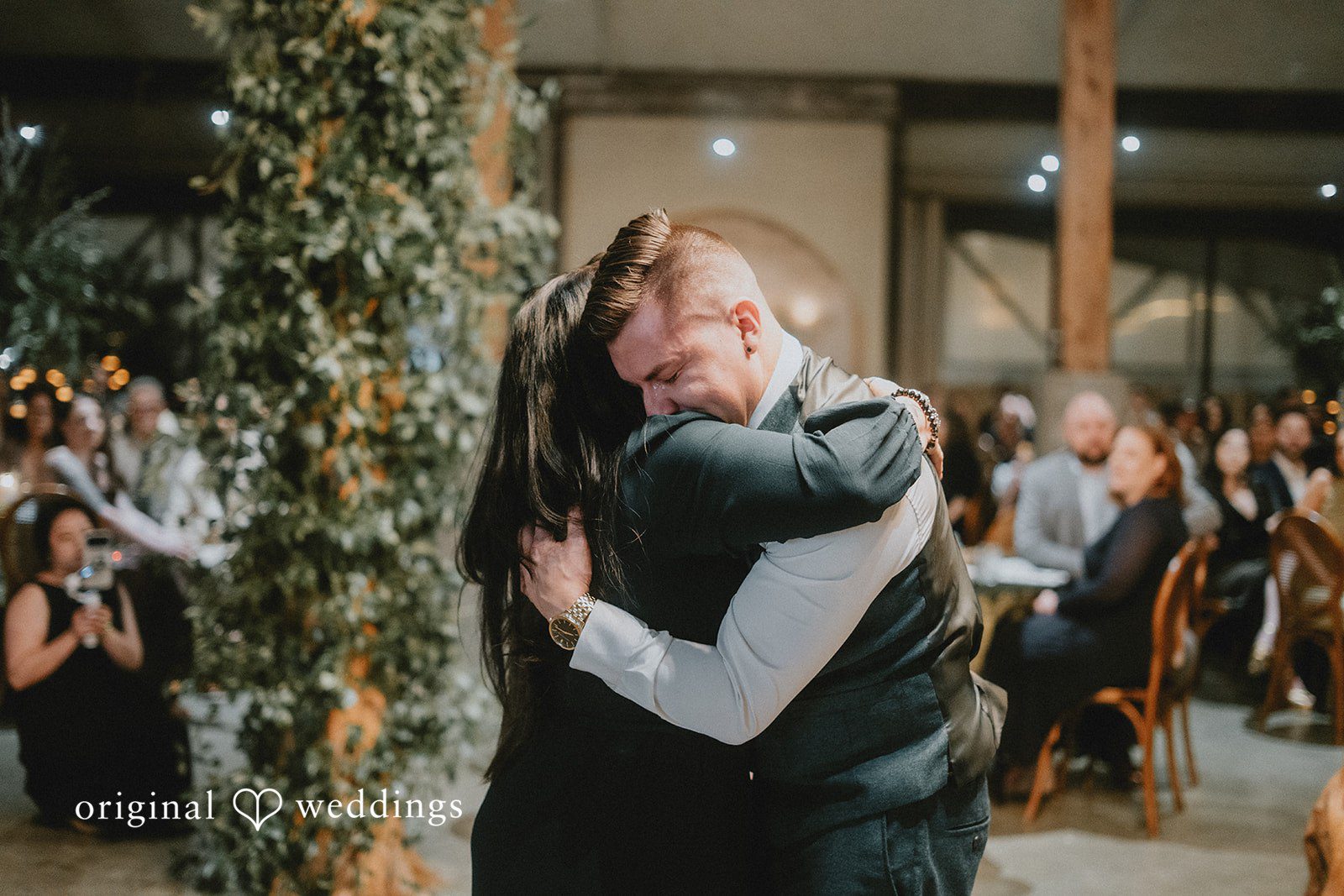 An emotional moment the groom shares a hug with family