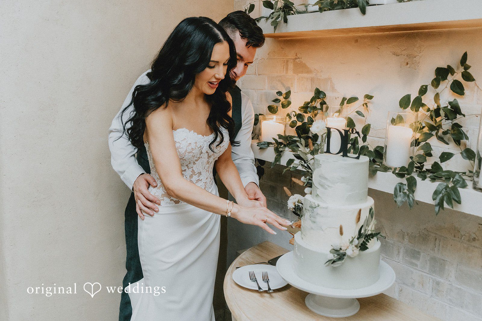 The couple cuts their wedding cake