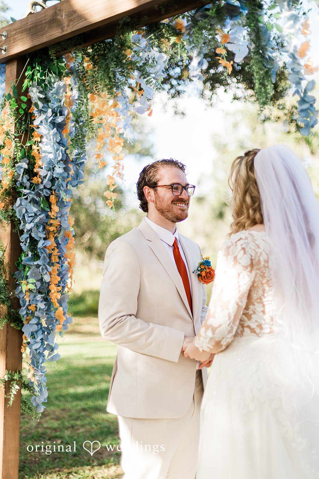 A close ceremony moment surrounded by floral décor, captured with Tampa Wedding Photography.