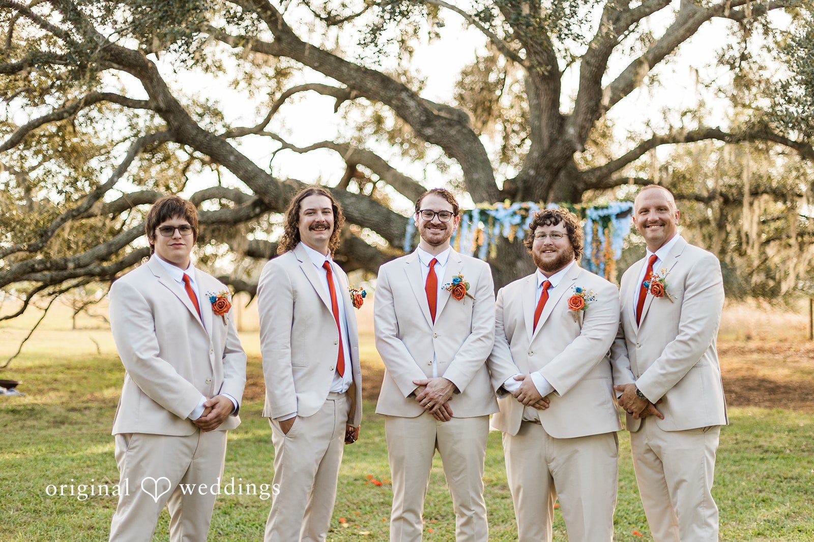 A wedding party group portrait beneath oak trees, arranged by Tampa Wedding Photography.