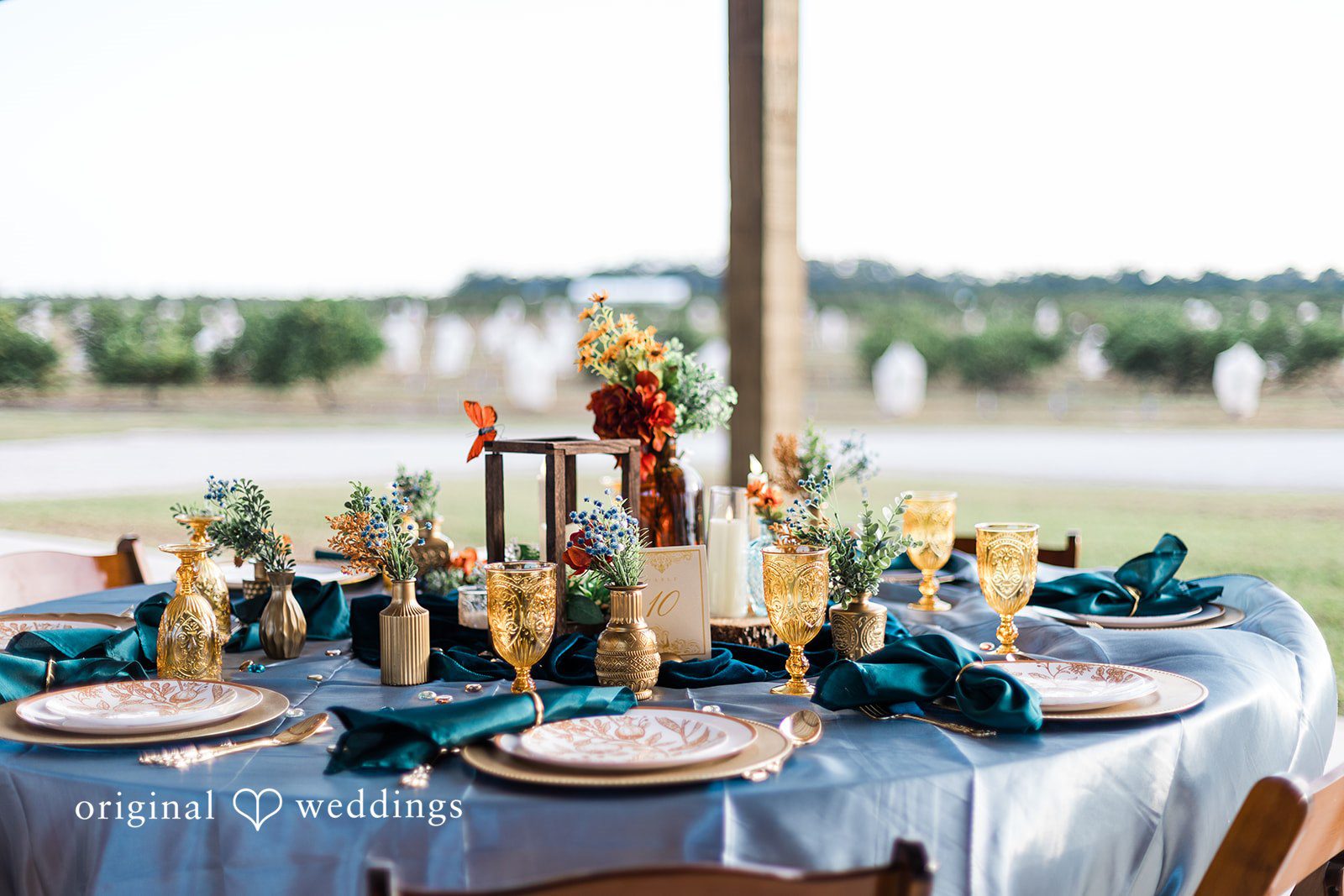 A long reception table overlooking the water, captured with thoughtful composition by Tampa Wedding Photography.