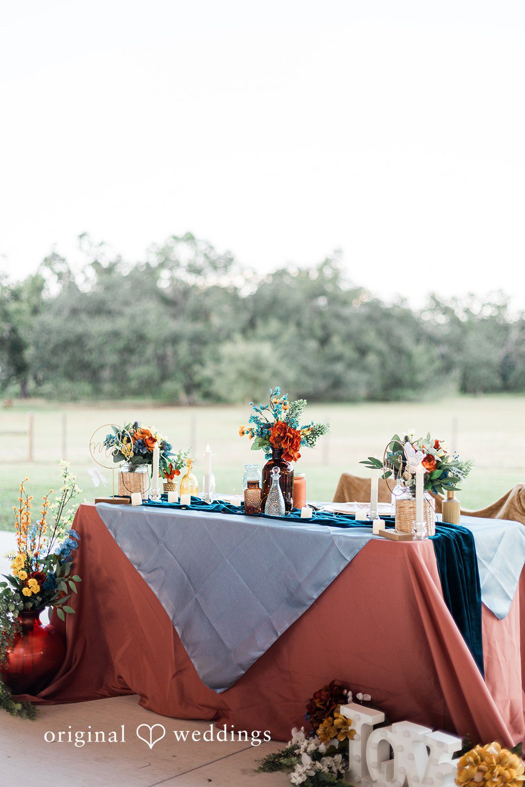A styled sweetheart table overlooking open land, photographed with refined details by Tampa Wedding Photography.