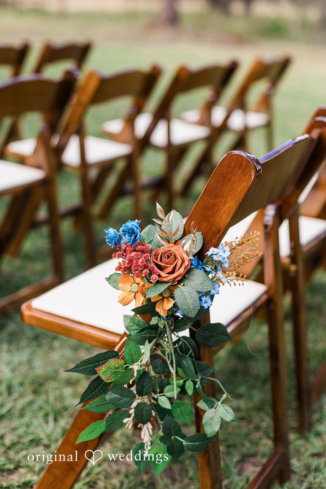 A ceremony chair decorated with florals along the aisle, highlighting subtle details of Tampa Wedding Photography.