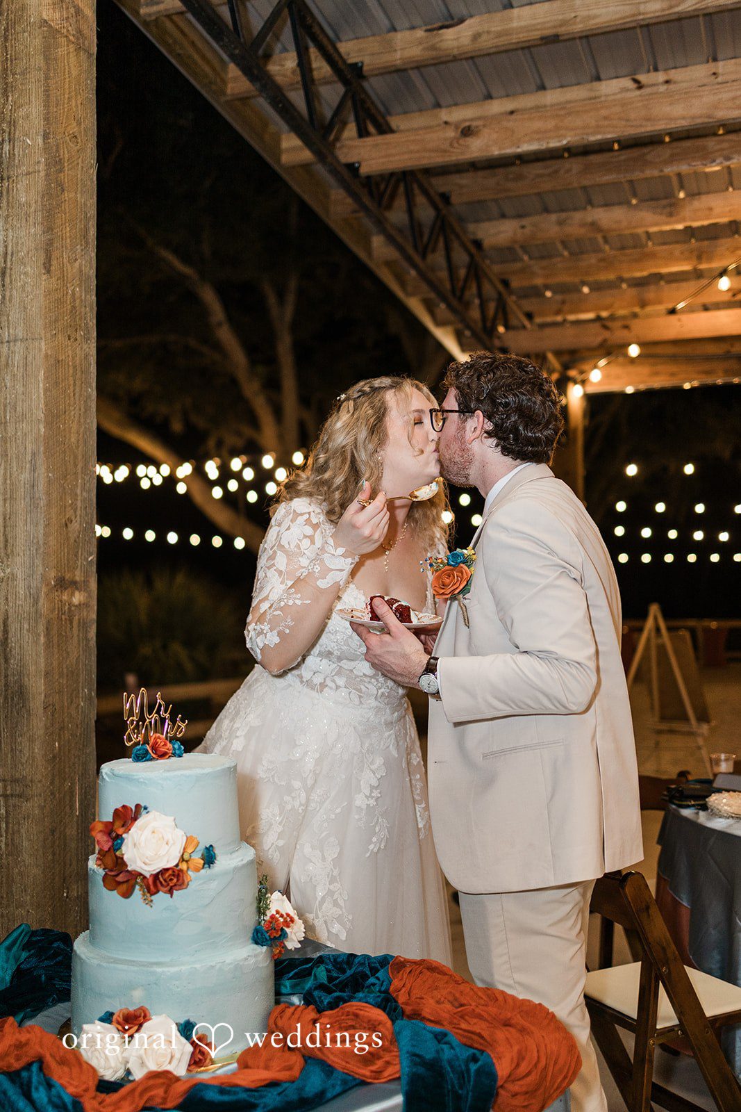 A joyful cake sharing moment under string lights, completing the story of Tampa Wedding Photography.