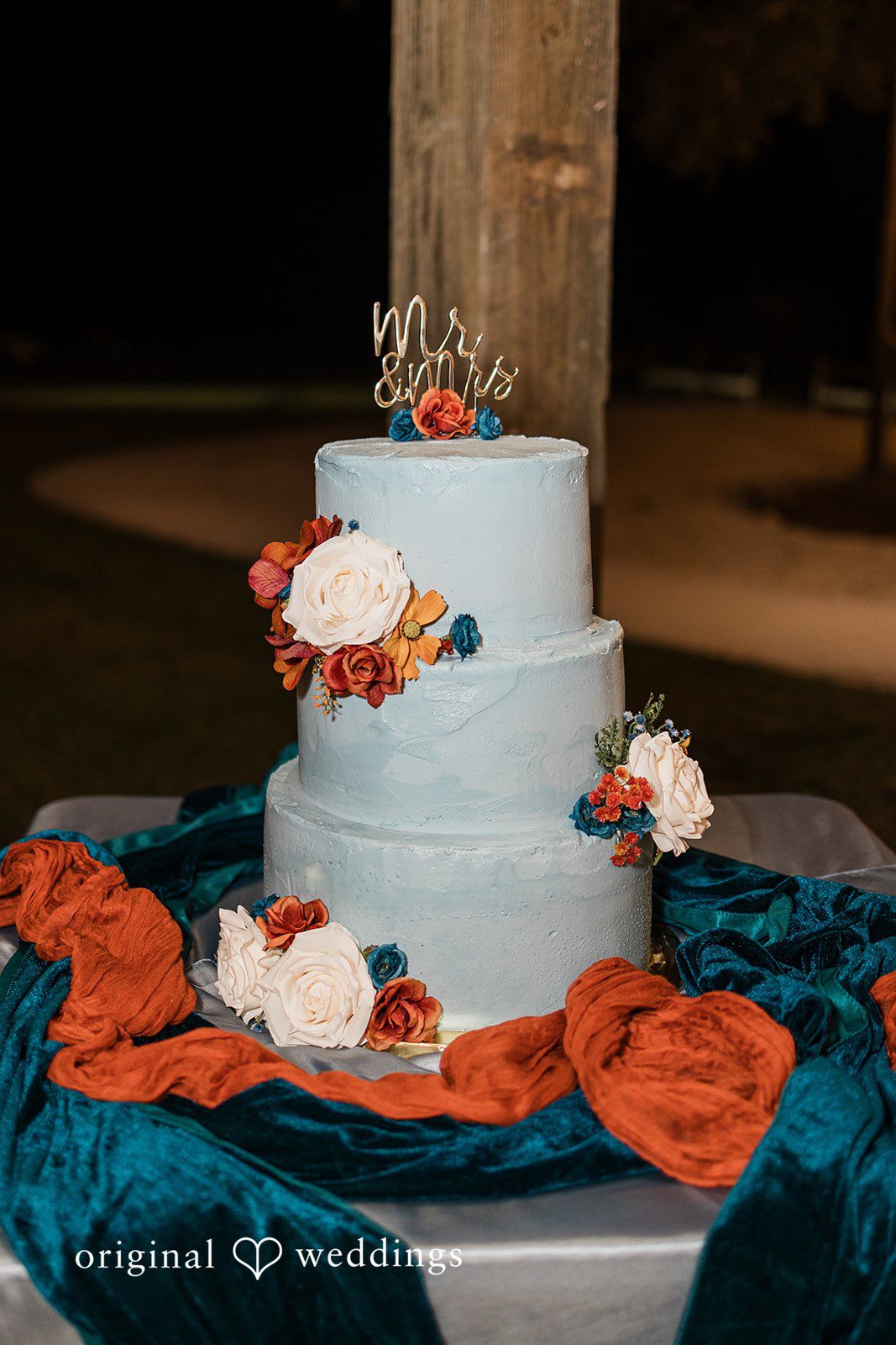 A multi-tier wedding cake displayed with elegant décor, photographed in a Tampa Wedding Photography aesthetic.