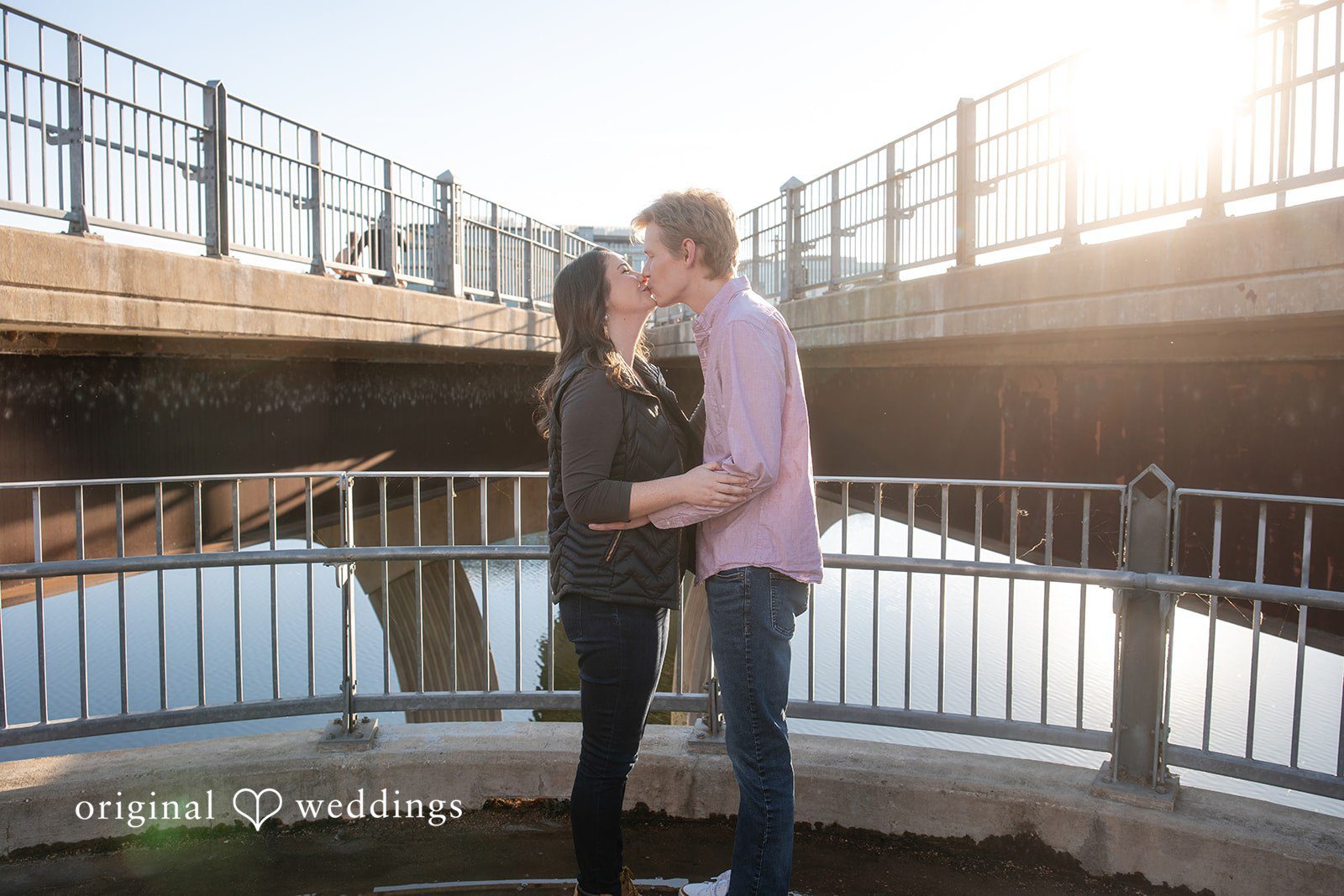 The couple shares a kiss by the Pfluger Pedestrian Bridge