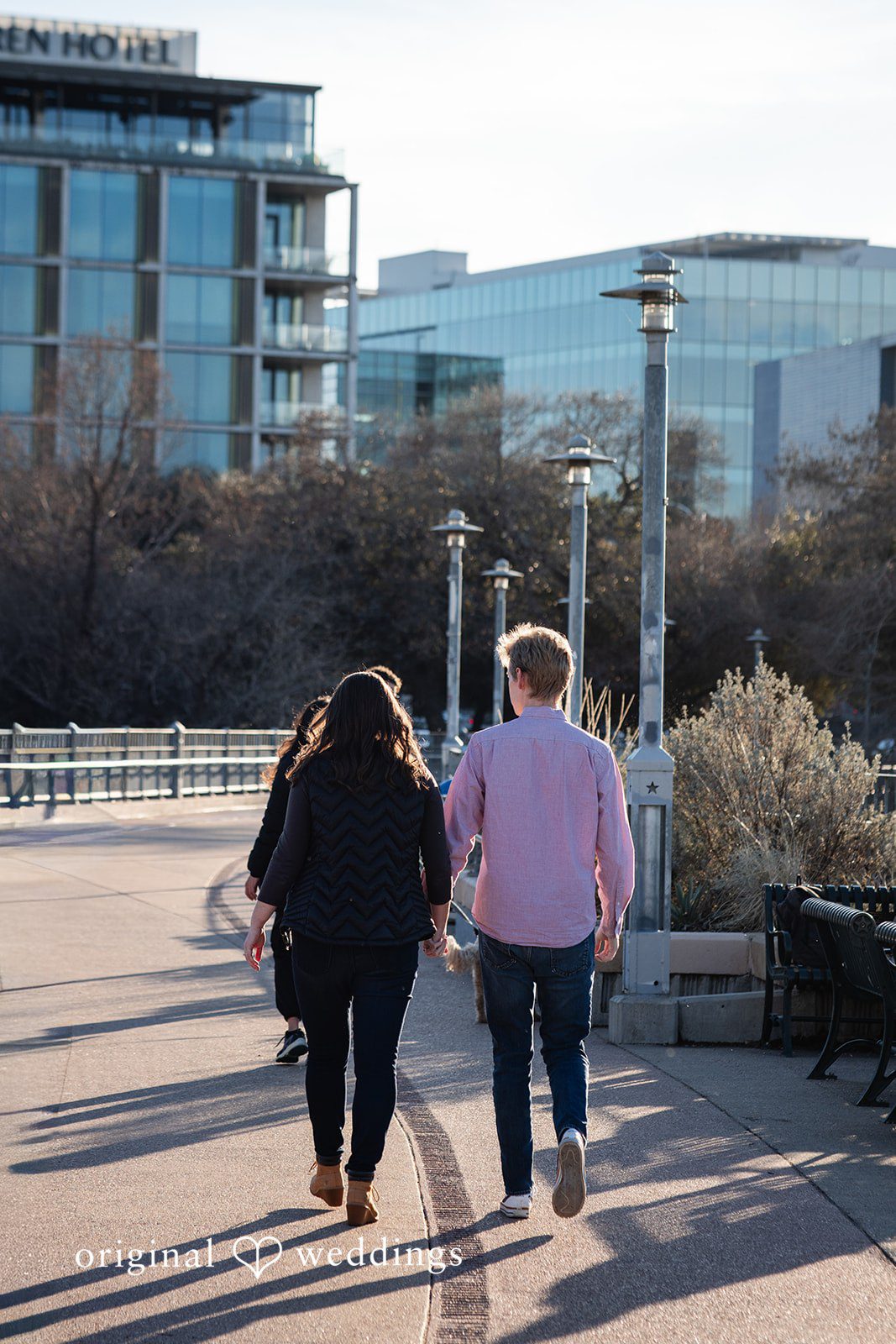 A back-view portrait of the couple taking a walk
