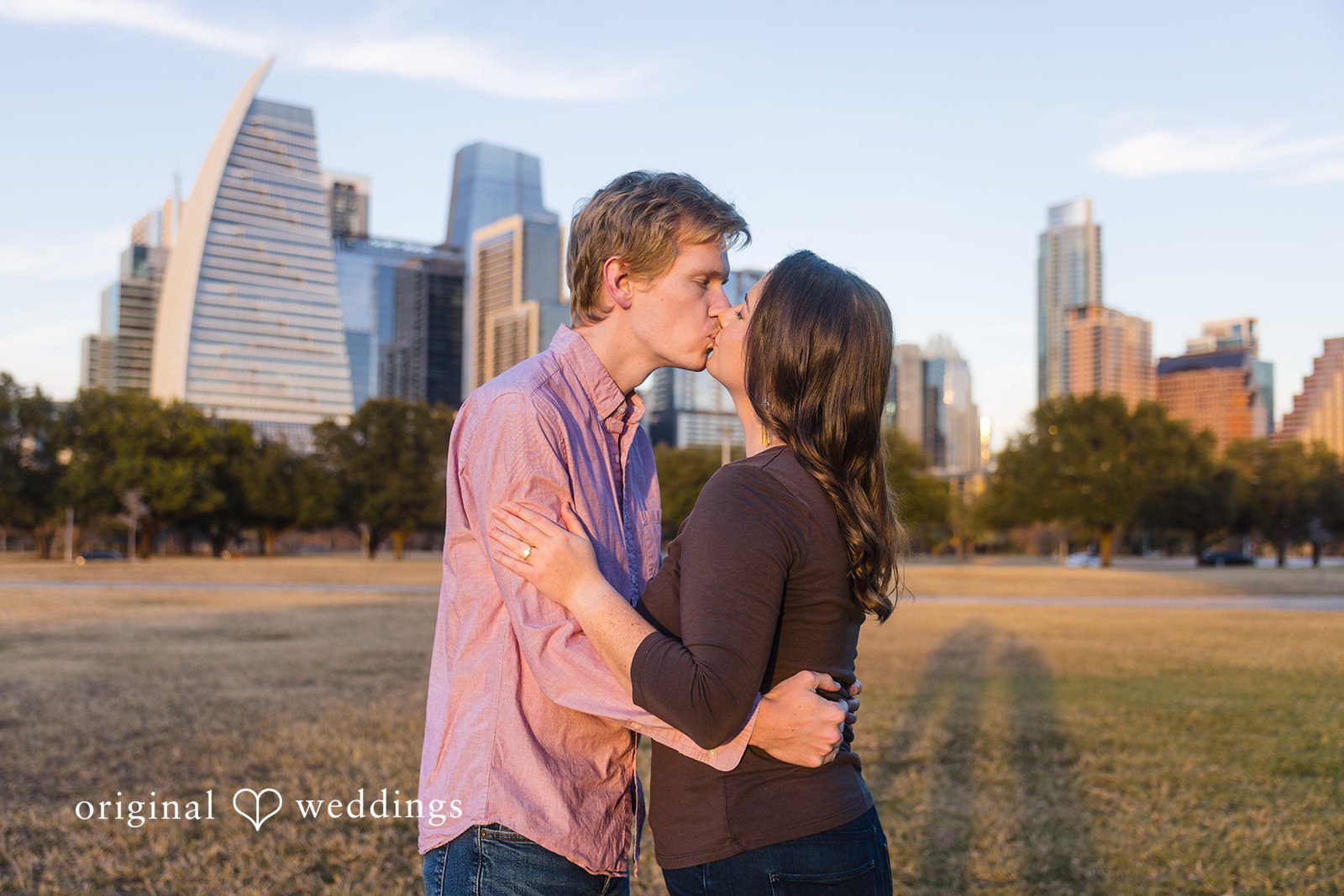 The couple shares a romantic kiss during their engagement session