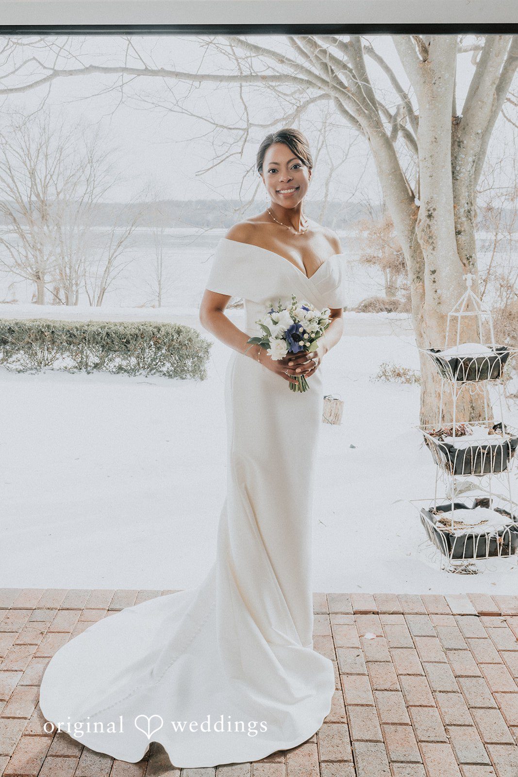 Beautiful bride smiling while holding floral bouquet at Cedar Knoll