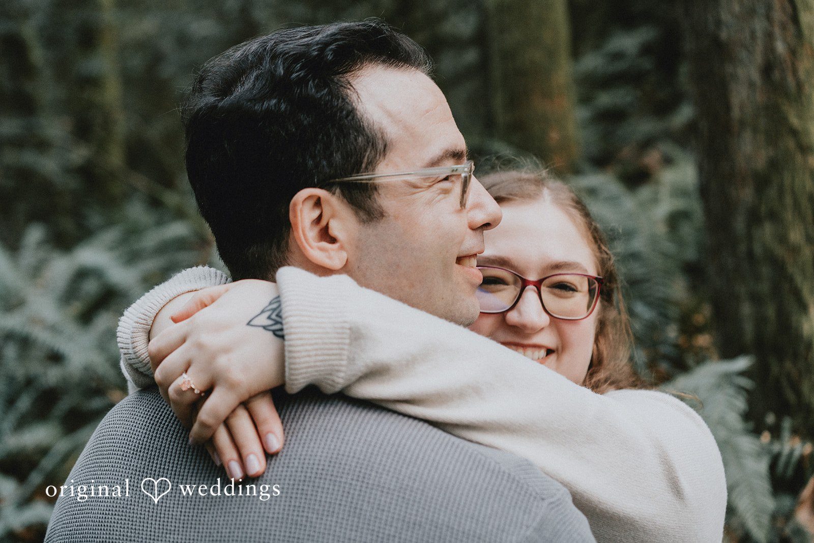 Couple sharing a warm embrace and smiling together.