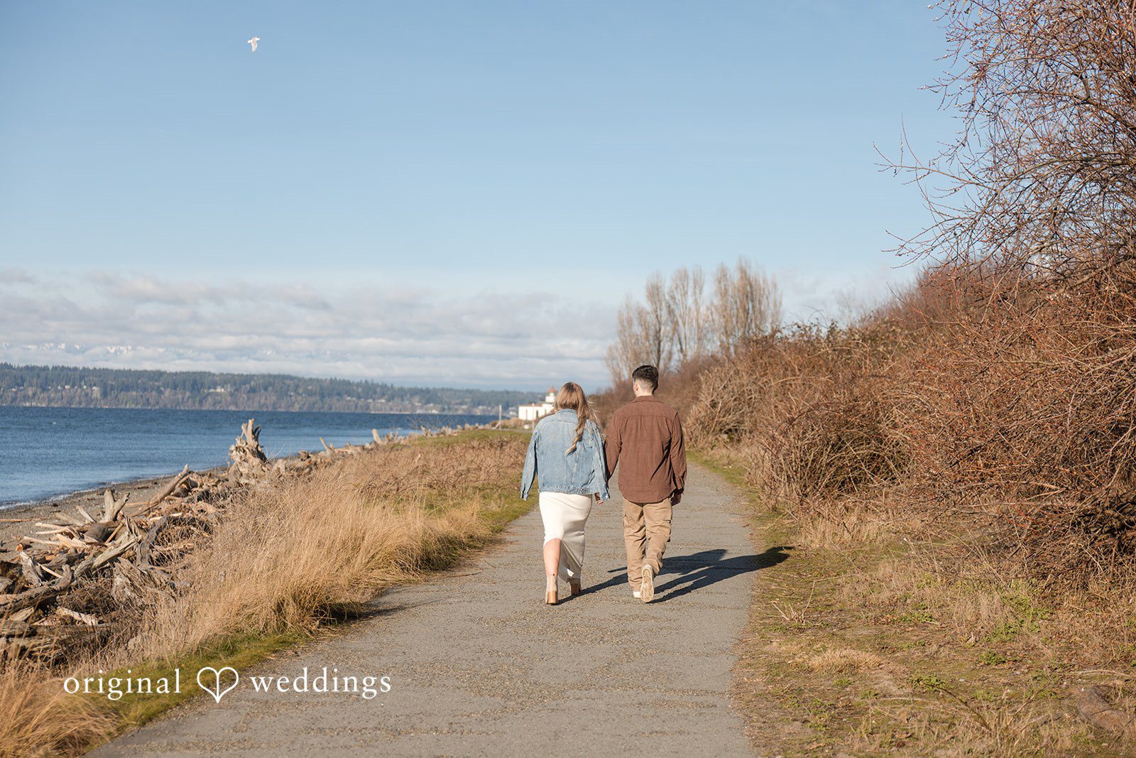 Peaceful engagement session with couple strolling along shoreline in Seattle