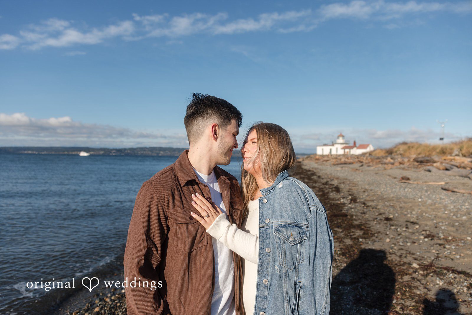 Natural connection captured during engagement photography session by shoreline