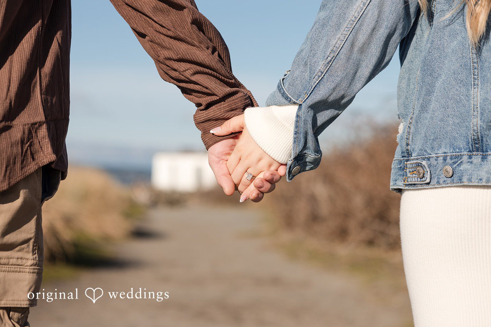 Romantic couple during engagement photography session with rings close-up
